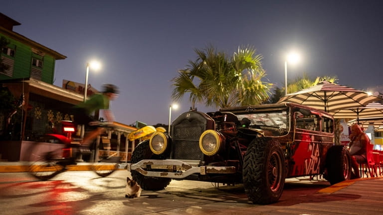A rat rod is seen parked in front of a...