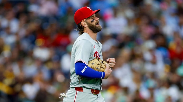 Philadelphia Phillies first basemen Bryce Harper reacts after a collision...