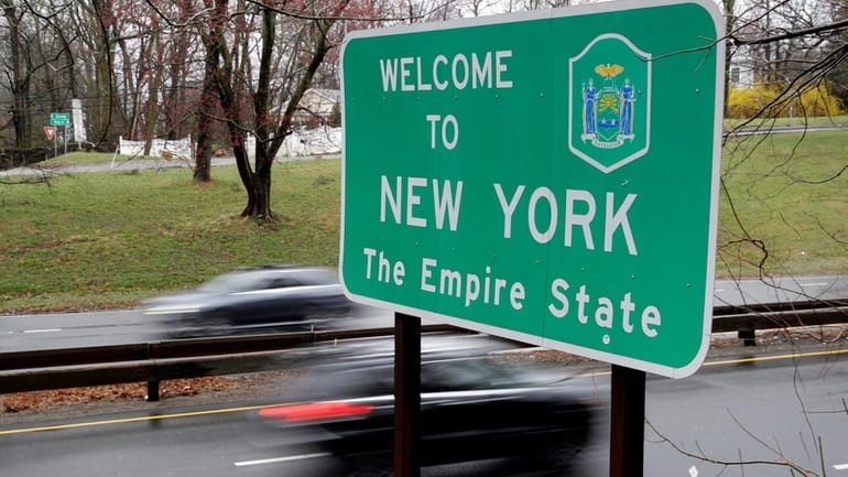 FILE — A sign welcomes motorists to New York, on...