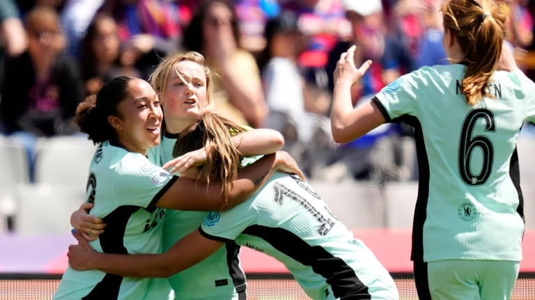 Chelsea's Erin Cuthbert, 2nd left, celebrates with her teammates after...