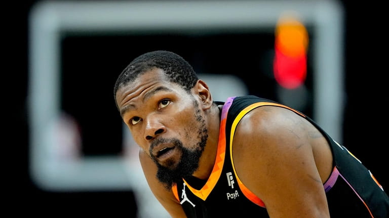 Phoenix Suns forward Kevin Durant looks at the scoreboard during...